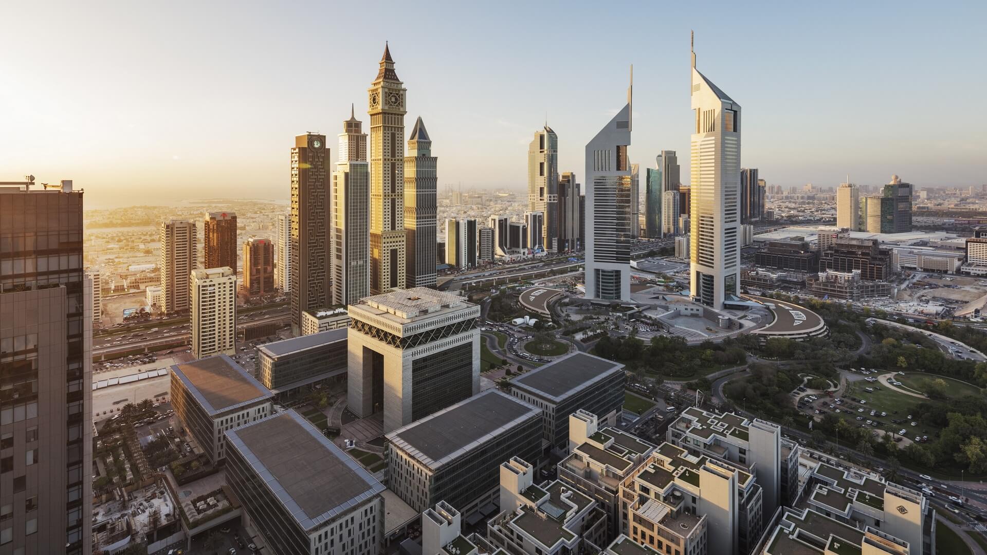 Aerial view of Dubai International Financial Centre (DIFC) skyline at sunset, highlighting its iconic skyscrapers.